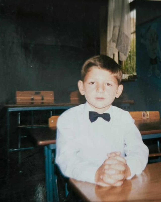 Young boy sitting at a desk in school